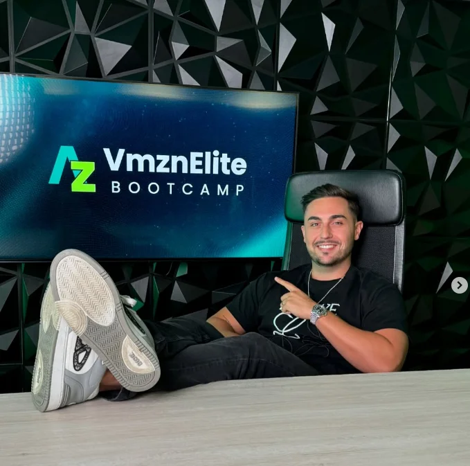 Mentor del curso AMZN Elite señalando la pantalla con el logo AMZN Elite Bootcamp en el set de grabación